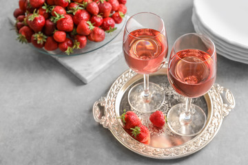 Glasses of strawberry wine on golden tray