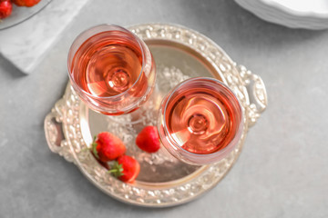 Glasses of strawberry wine on golden tray