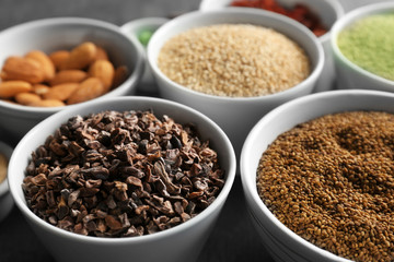 Composition with assortment of superfood products in bowls, closeup