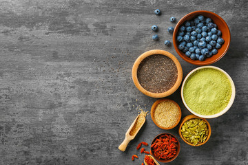 Composition with assortment of superfood products in bowls, top view