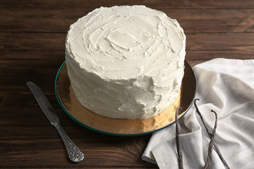 Delicious vanilla cake with whipped cream on table