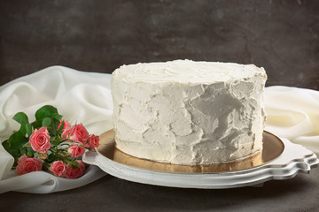 Delicious vanilla cake with whipped cream on table