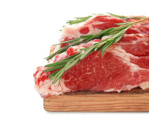 Wooden board with fresh raw meat and rosemary on white background