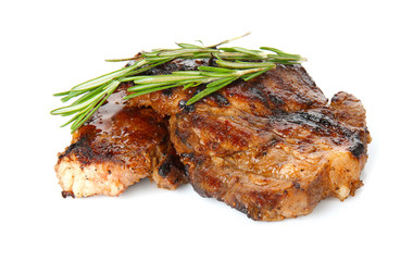 Tasty steaks with rosemary on white background