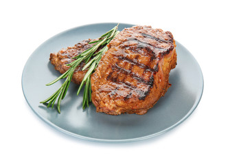 Plate with tasty steaks on white background