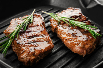 Grill pan with tasty steaks, close up