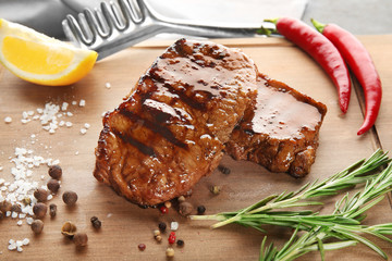 Tasty grilled steaks on wooden board