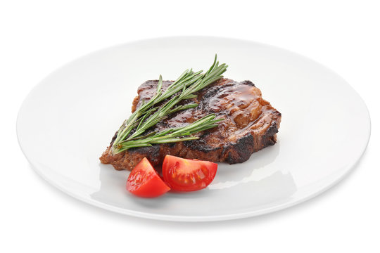 Plate with tasty steak on white background