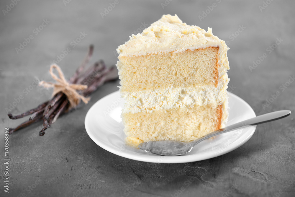 Wall mural piece of delicious vanilla cake on table