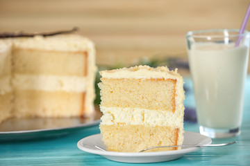 Piece of delicious vanilla cake on table