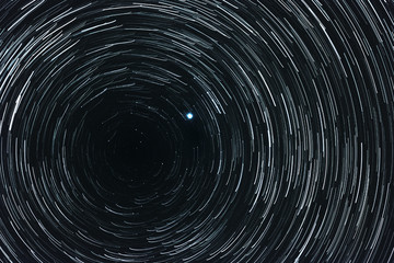 Collage of starry sky with trails and Polar star in the center