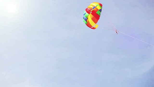 Parachuter is pulled by a motor boat at sea