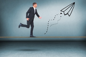 Composite image of businessman walking with his hands out