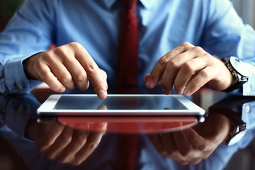 Young adult working on a digital tablet.