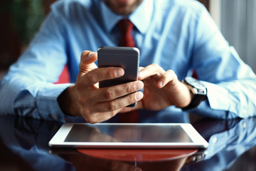 Businessman using digital tablet computer with modern mobile phone. New technologies for success workflow concept