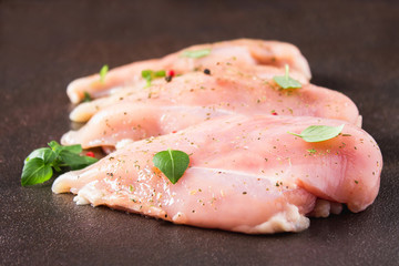 Raw fillet of chicken on rusty background. Meat ingredients for cooking. Top view.