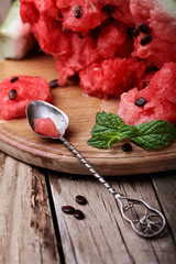Watermelon.loseup watermelon and leaf of mint on vintage spoon onwooden rustic table with.Selective focus.