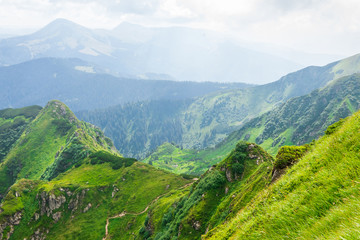 Fototapeta na wymiar Travel, trekking, nature. Majestic, high green mountains. Horizontal frame
