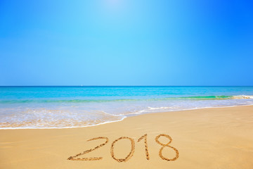 Fototapeta na wymiar 2018 written on sandy beach