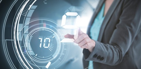Composite image of businesswoman touching invisible digital
