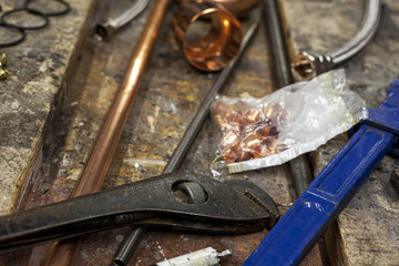 Adjustable wrenches on a cluttered old workbench