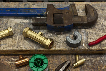Various valves and wrenches on a plumbers workbench
