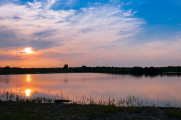 Fototapeta na wymiar Summer landscape: the setting sun over the lake