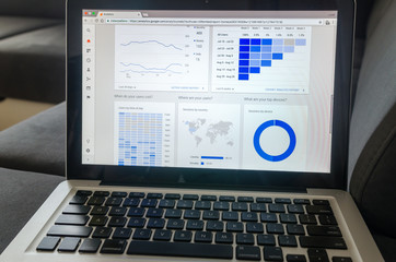 Notebook work with statistics on sofa business