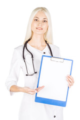 Smiling female doctor assistant scientist in white coat over white isolated background with white blank board