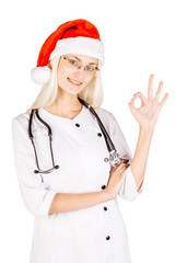 Portrait of smiling doctor woman in santa hat