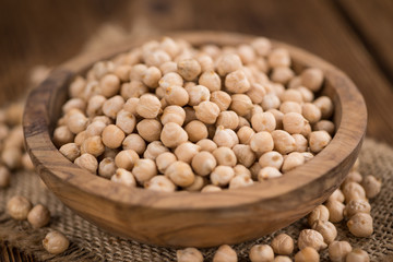 Dried Chickpeas on wooden background; selective focus