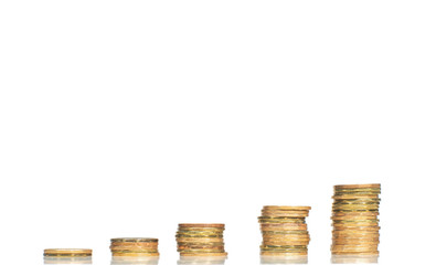 Five stacks of coins forming steps up isolated on white background