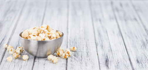 Portion of Popcorn on wooden background, selective focus