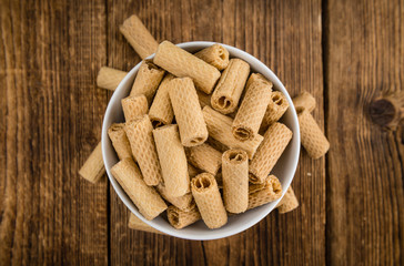 Sweet Wafers on wooden background; selective focus