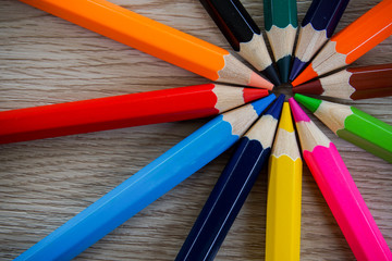 Naklejka premium Color pencils and compass isolated on wooden background.Close up.