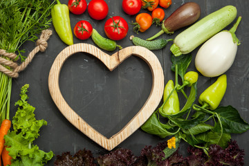 Raw vegetables on a black wooden background