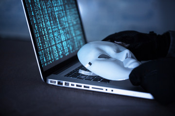 Hacker wear an anonymous mask.