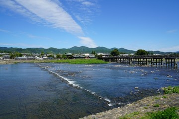 Naklejka na ściany i meble 京都の嵐山　保津川(桂川)に架かる渡月橋と河原の風景