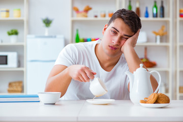 Man falling asleep during his breakfast after overtime work