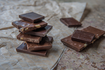 Dark chocolate stack with hazelnuts. Sweet dessert