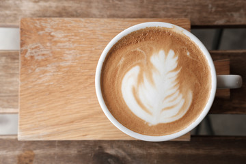 A cup of coffee put on wooden board