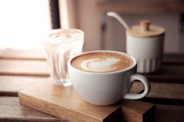 A cup of coffee put on wooden board