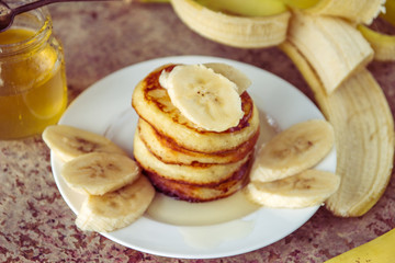 Fototapeta na wymiar Pancakes with bananas and honey. Homemade breakfast