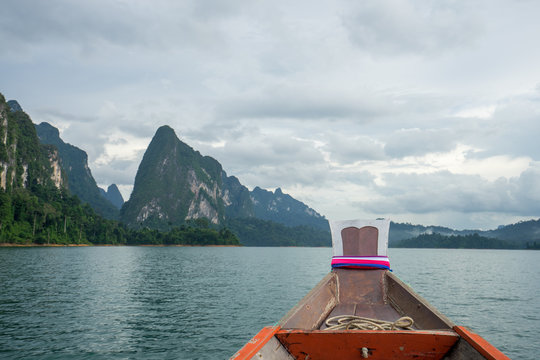 Boat tail to sail see scenic and unique landscape with floating houses and long tail boats at Chieou Laan lake, Thailand