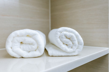 Obraz na płótnie Canvas towel roll on bathroom shelf