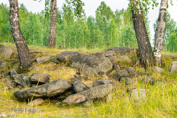 Natural Stones and rocks bulk in forest with birchs, The Urals mountain, Russia