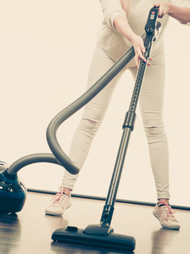 Woman legs and vacuum cleaner