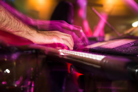 Musician plays keyboards in a rock band