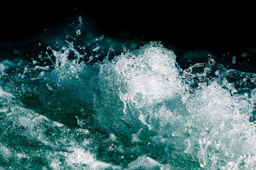 Splash of stormy water in the ocean on a black background