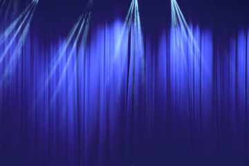 soft blue curtain with light in theater